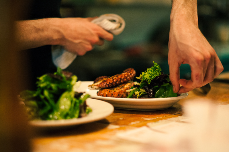 A person is cutting food on a plate.